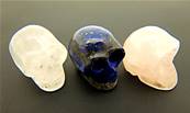 SET OF THREE GEMSTONE SKULLS IN VELVET POUCH. SP9234POL