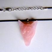 CARVED WOLF'S HEAD PENDANT IN ROSE QUARTZ ON WAXED CORD.   SPR13948PEND