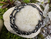 HEMATITE SPRUNG WIRE BRACELET FEATURING ROUND AND OVAL BEADS.   SPR14533BRWH