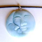 MAN IN THE MOON CARVED PENDANT IN CHINESE AMAZONITE ON WAXED CORD.   SPR13954PEND